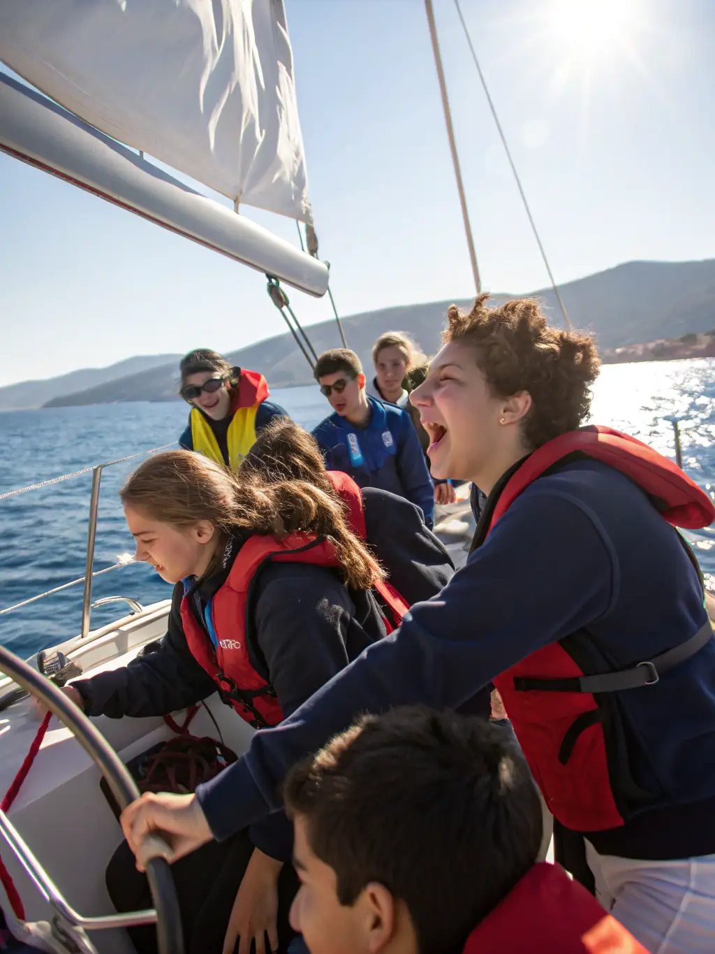 A group of students on a guided tour of a historic sailing vessel, listening attentively to a guide explaining the boat's history and construction.